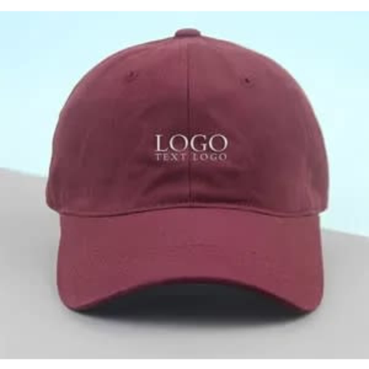 A burgundy cap featuring a logo on the front, with a classic design and curved brim.