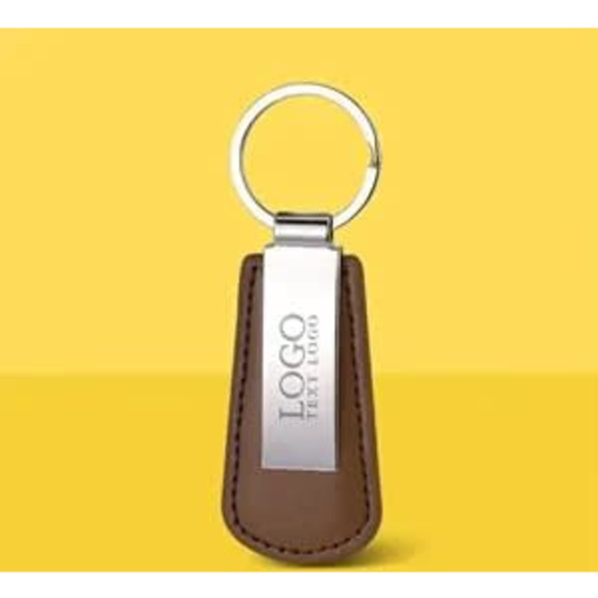 A brown vegan leather drop-shaped keychain with a silver ring and a logo on the front.
