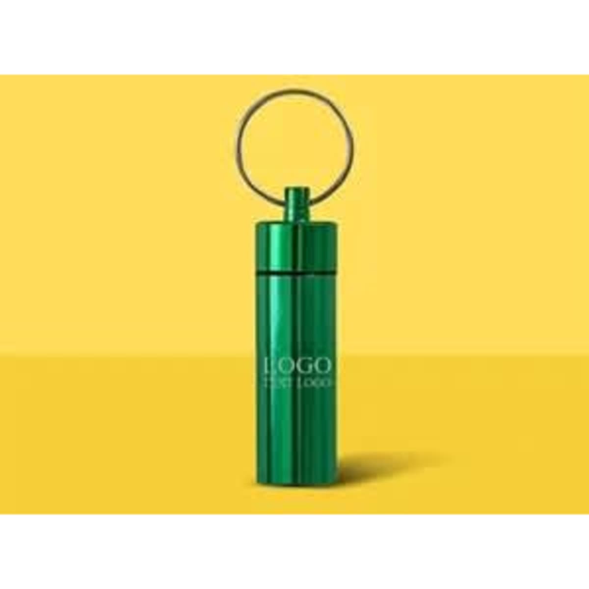 A green waterproof pill box keychain with a keyring attachment and a logo.