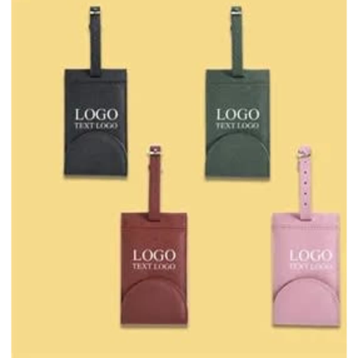 A set of travel leather luggage tags in green, dark green, burgundy, and pink, each featuring a logo.