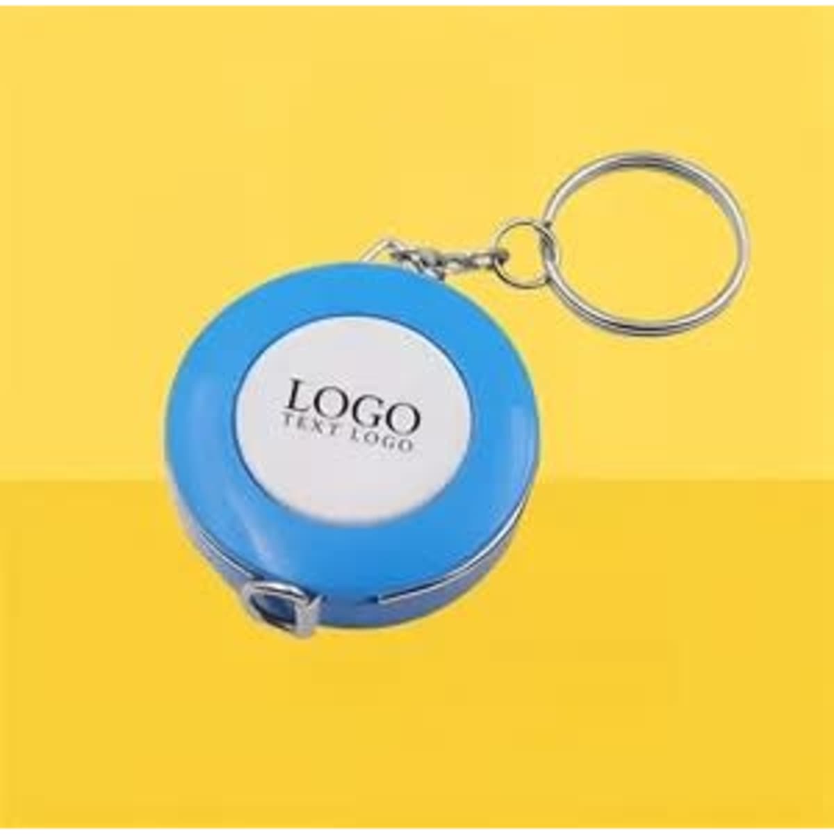 A blue retractable plastic round tape measure keychain featuring a logo on the front.