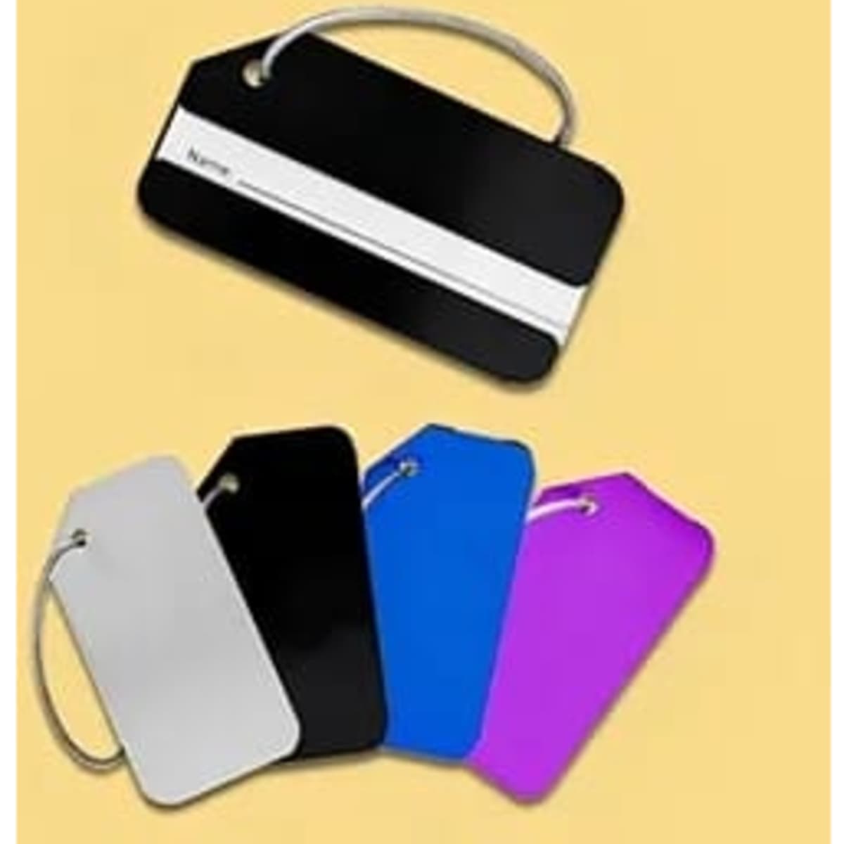Aluminium luggage tags in black, white, blue, pink, and silver, featuring a name card slot and a hanging loop.