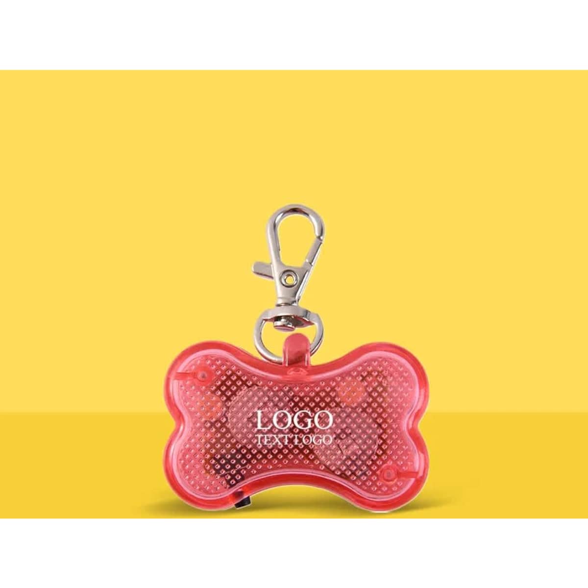 A red bone-shaped key light with a clip attachment and a logo on the surface against a yellow background.