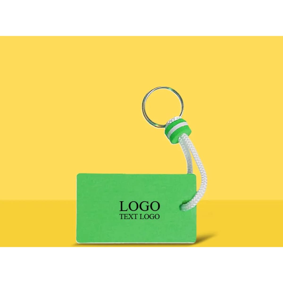 A green rectangular keychain with a white rope attachment and a circular metal ring. It features a logo.