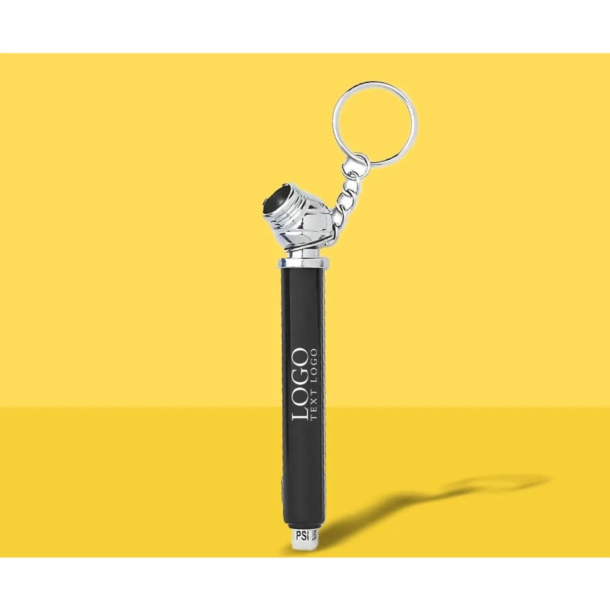 A black mini tire gauge keychain with a silver attachment, featuring a logo on the body.