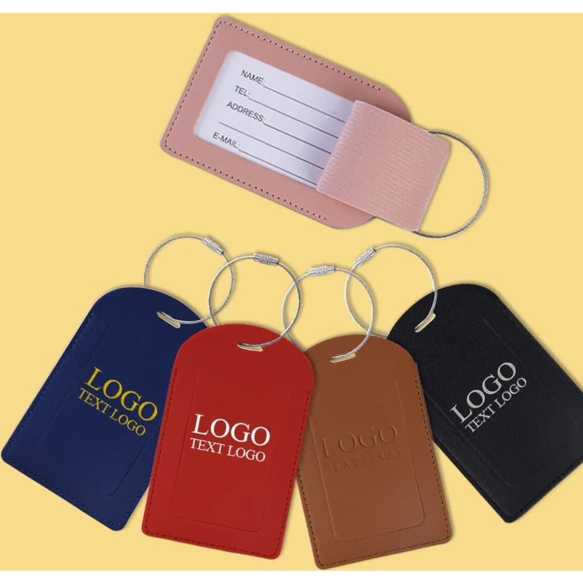 A set of vegan leather luggage tags in blue, brown, red, and black with a logo and a removable card for personal details.