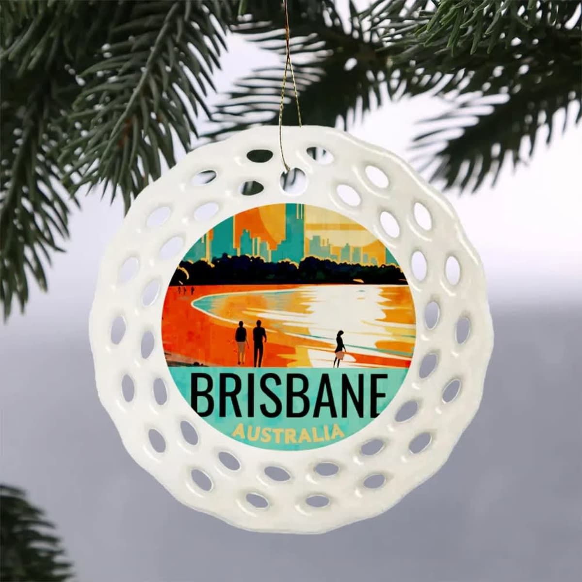 A white decorative bauble featuring a design of Brisbane, Australia, with silhouettes and vibrant colours.