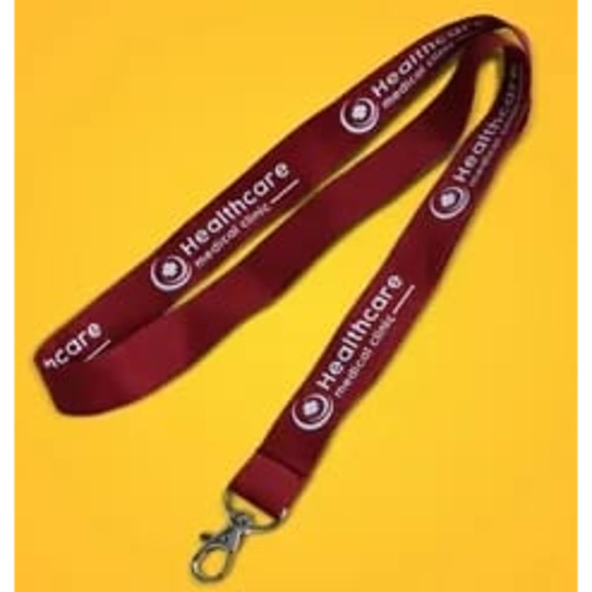 A red cotton lanyard with a logo and a metal clip for attachment.