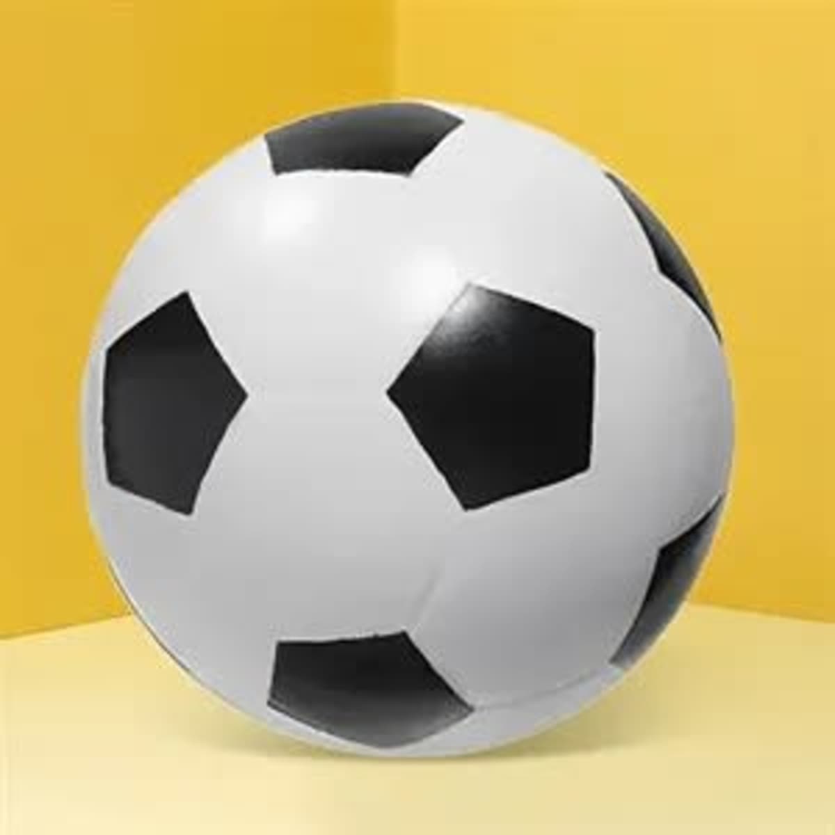 A round soccer stress ball featuring black and white panels, set against a yellow background.