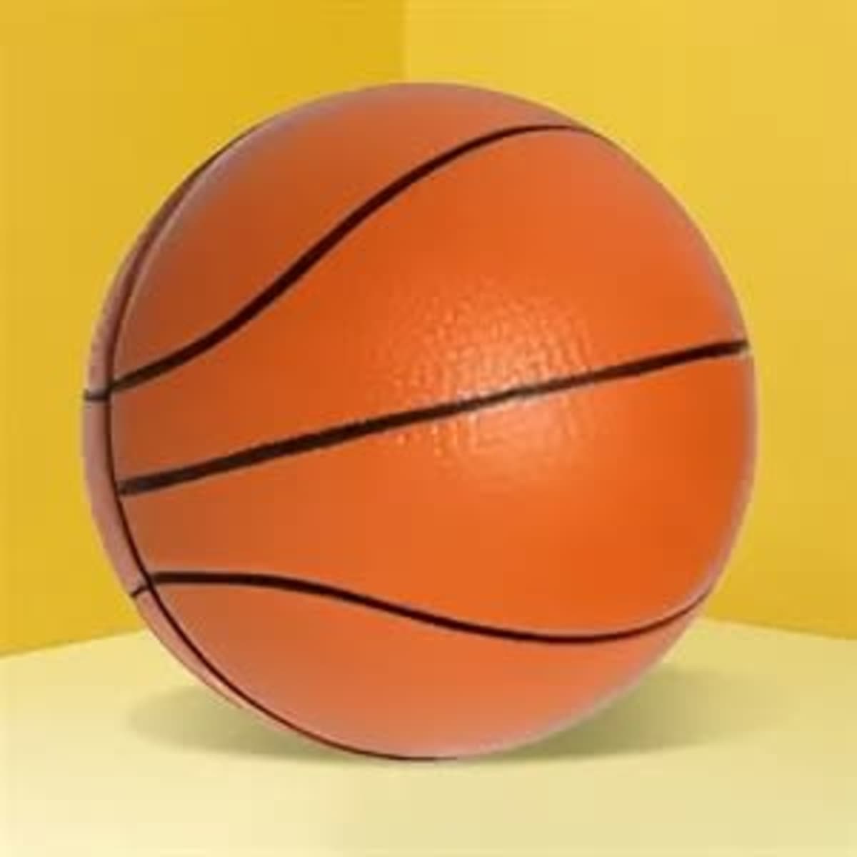 An orange basketball stress ball with black lines, set against a yellow background.