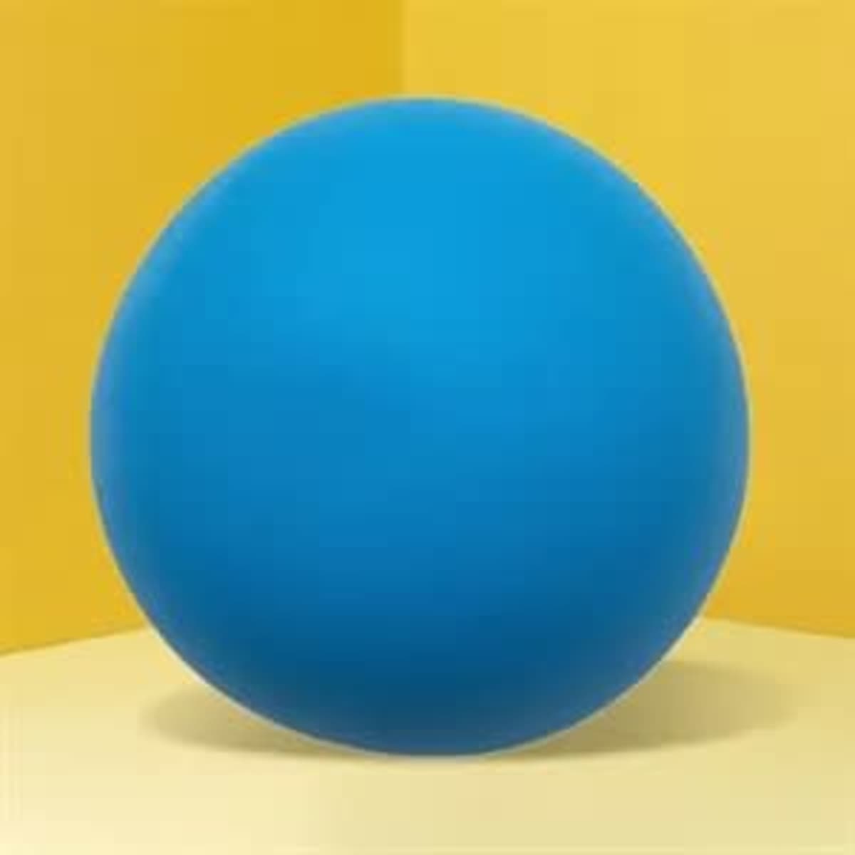 A blue stress ball sits on a yellow background. The ball is round and smooth in appearance.