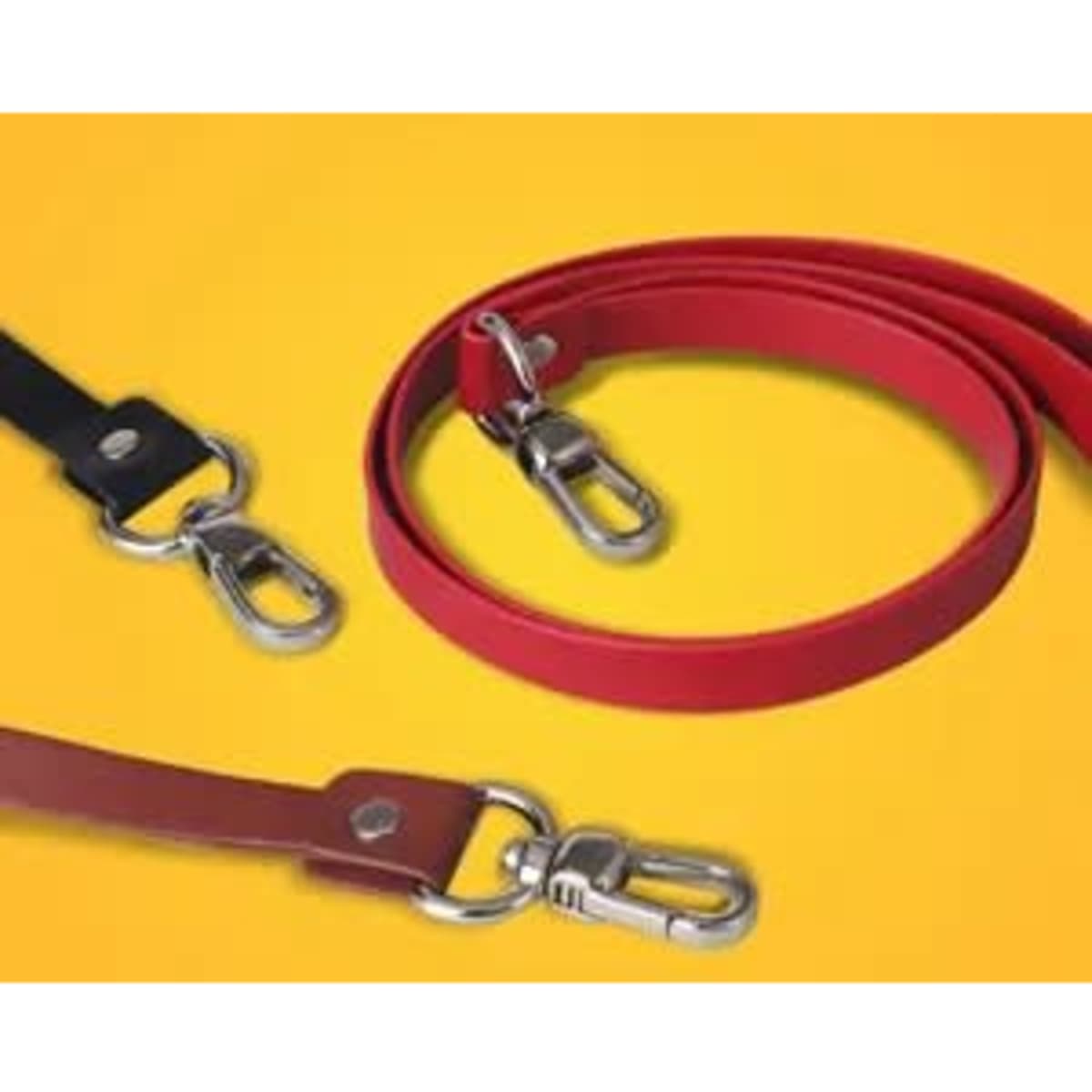 Three vegan leather lanyards in black, red, and brown with metal clips, displayed against a yellow background.