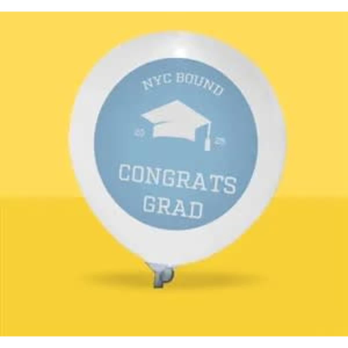A white balloon with a light blue design featuring a graduation cap and the text "Congrats Grad" against a yellow background.