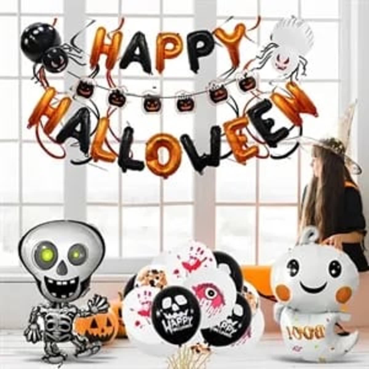 A display of Halloween-themed balloons in black, orange, and white, featuring a skeleton, ghosts, and festive lettering.