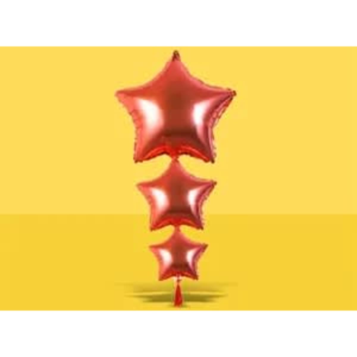 A trio of red star-shaped balloons with a tassel at the bottom, set against a bright yellow background.