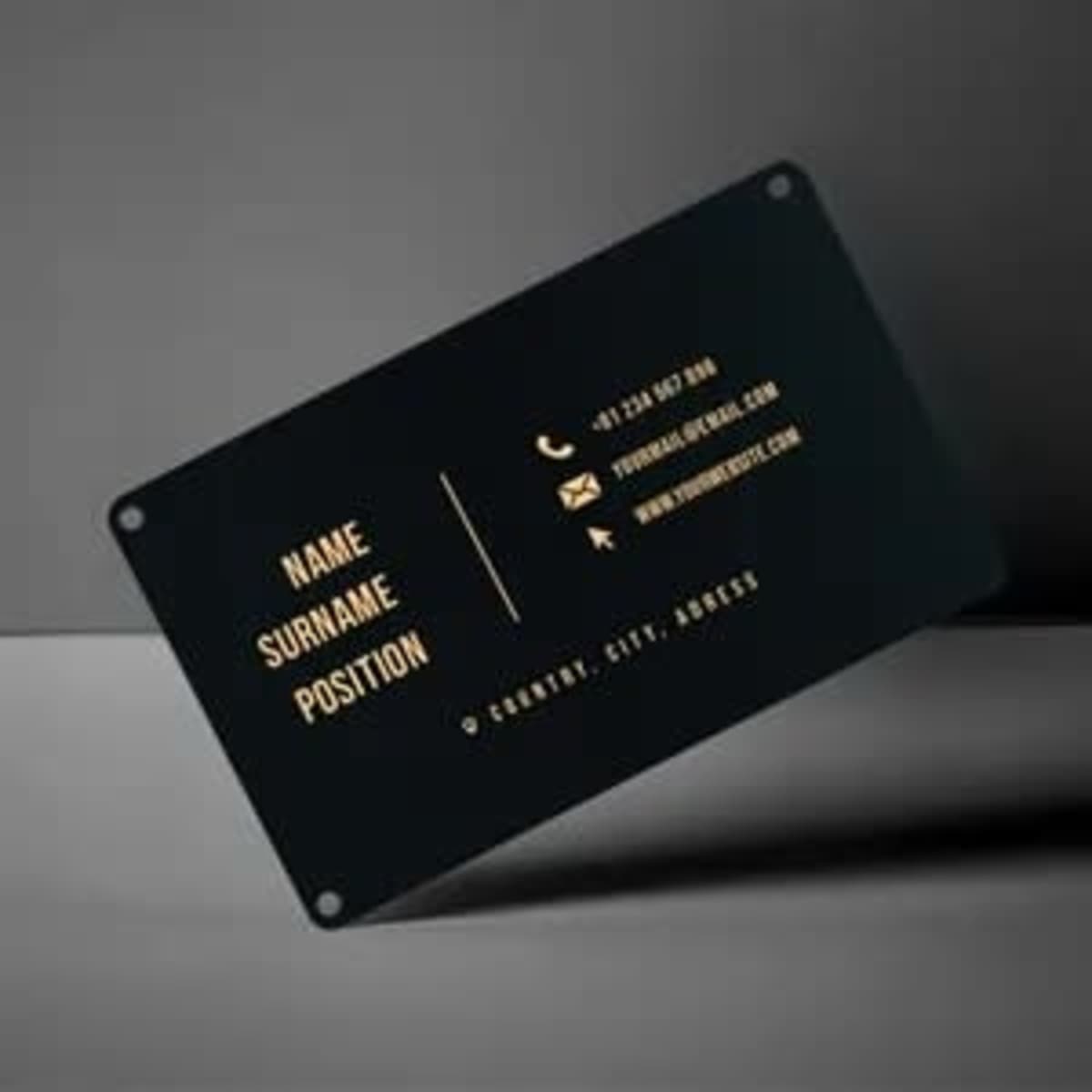 A black aluminium business card with gold text, featuring a logo, contact details, and space for personal information.