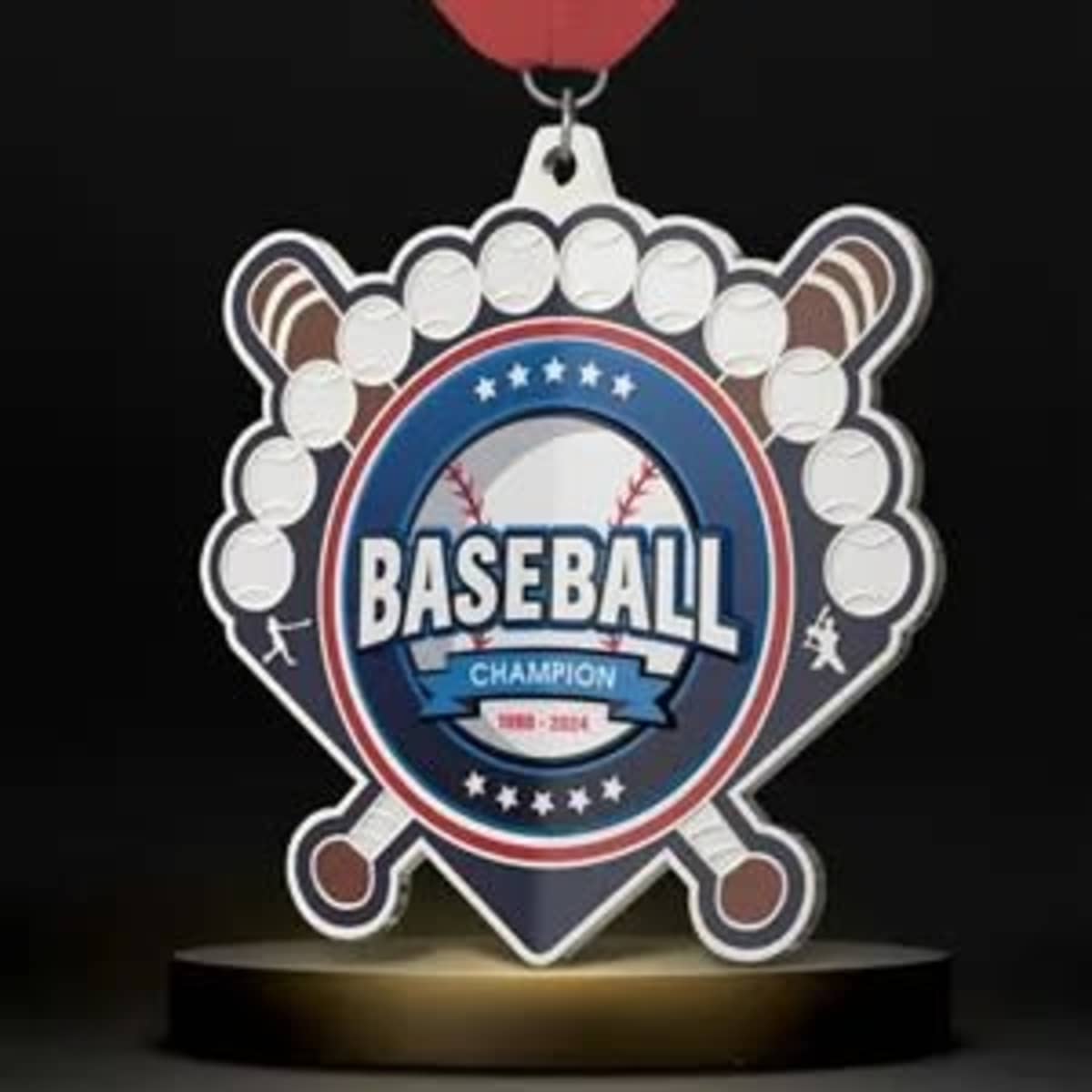 A baseball medal featuring a central emblem, with red, blue, and white colours, and a ribbon for hanging.