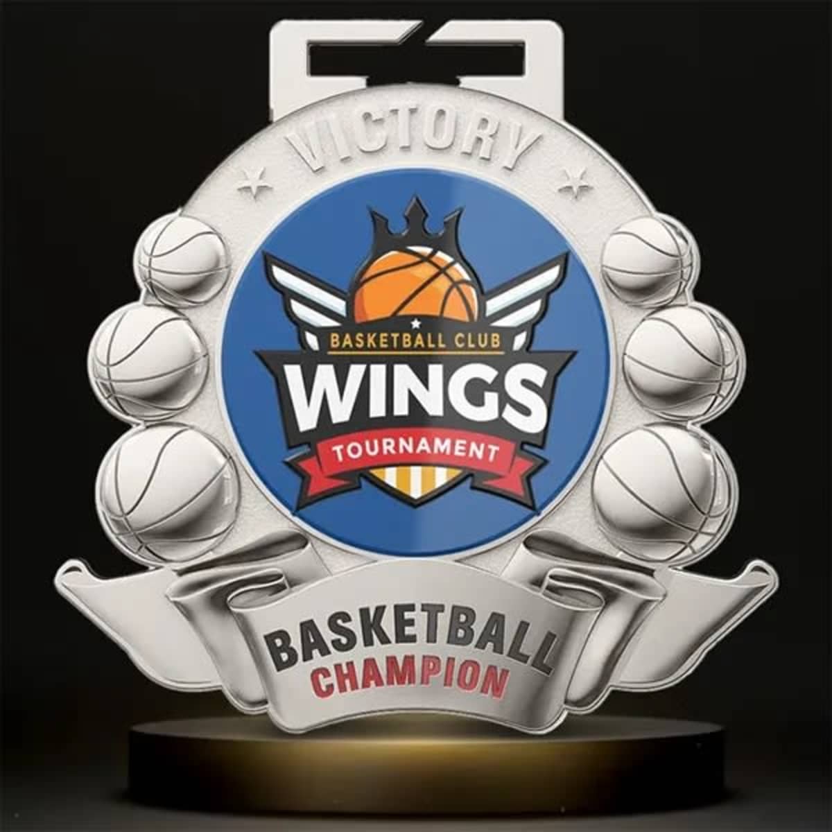 A silver basketball medal featuring a blue and orange logo, with basketball illustrations and a decorative design.