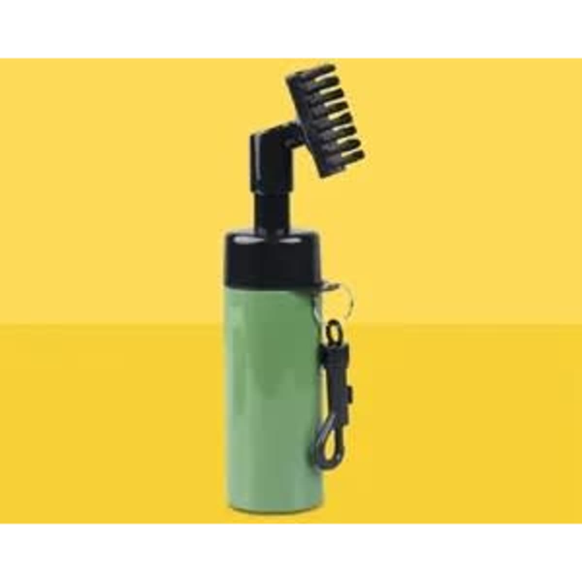 A green bottle with a black spray nozzle and brush attachment, featuring a keychain clip.