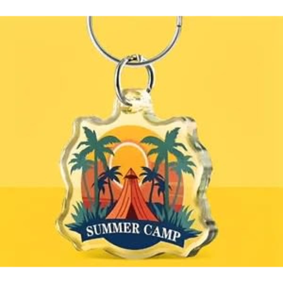A custom acrylic keychain featuring a summer camp design with palm trees and a tent, set against a vibrant yellow background.