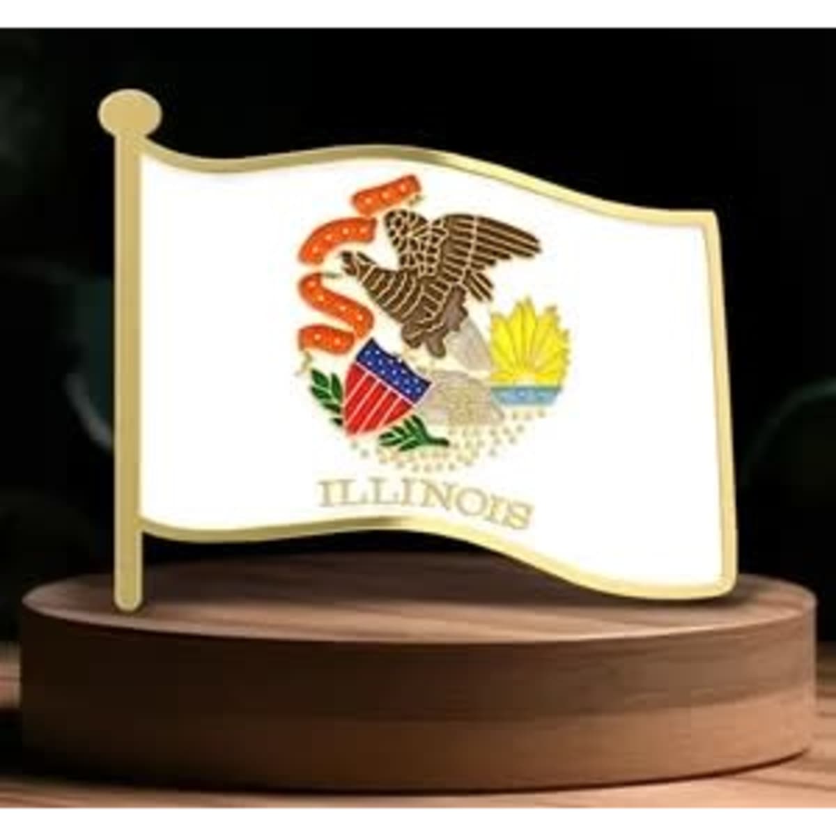 A decorative pin featuring the Illinois state flag on a wooden display base, showcasing white, gold, and multi-coloured elements.
