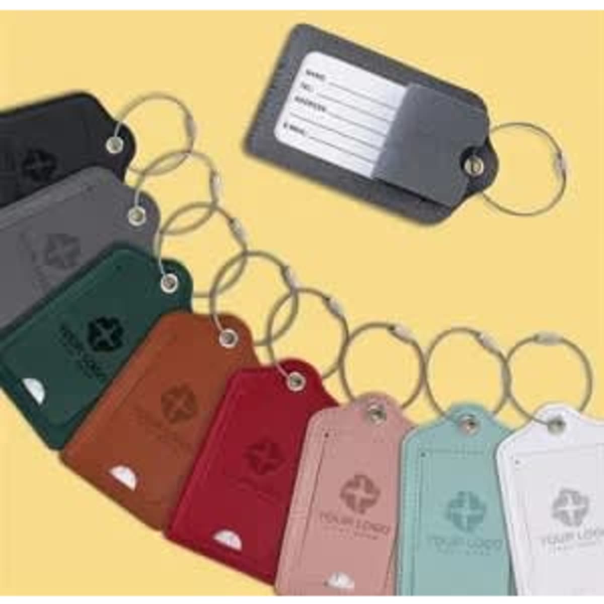 A set of eight stylish luggage tags in various colours, each featuring a keyring and a label for personal information.
