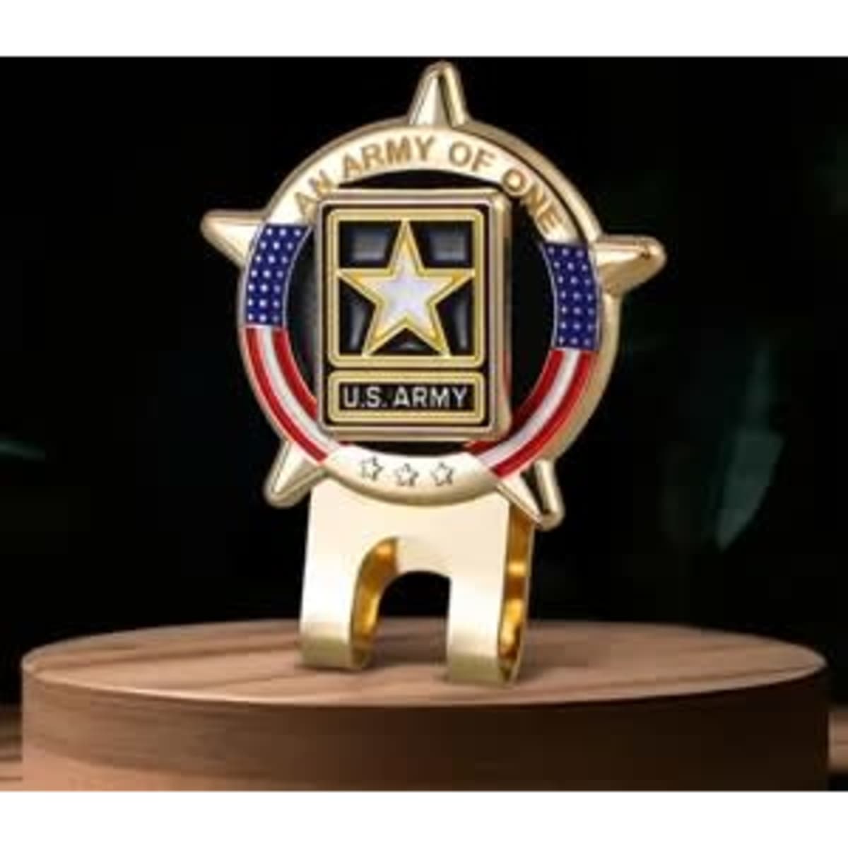A gold U.S. Army hat clip featuring a star, red and blue accents, and a circular design on a wooden base.
