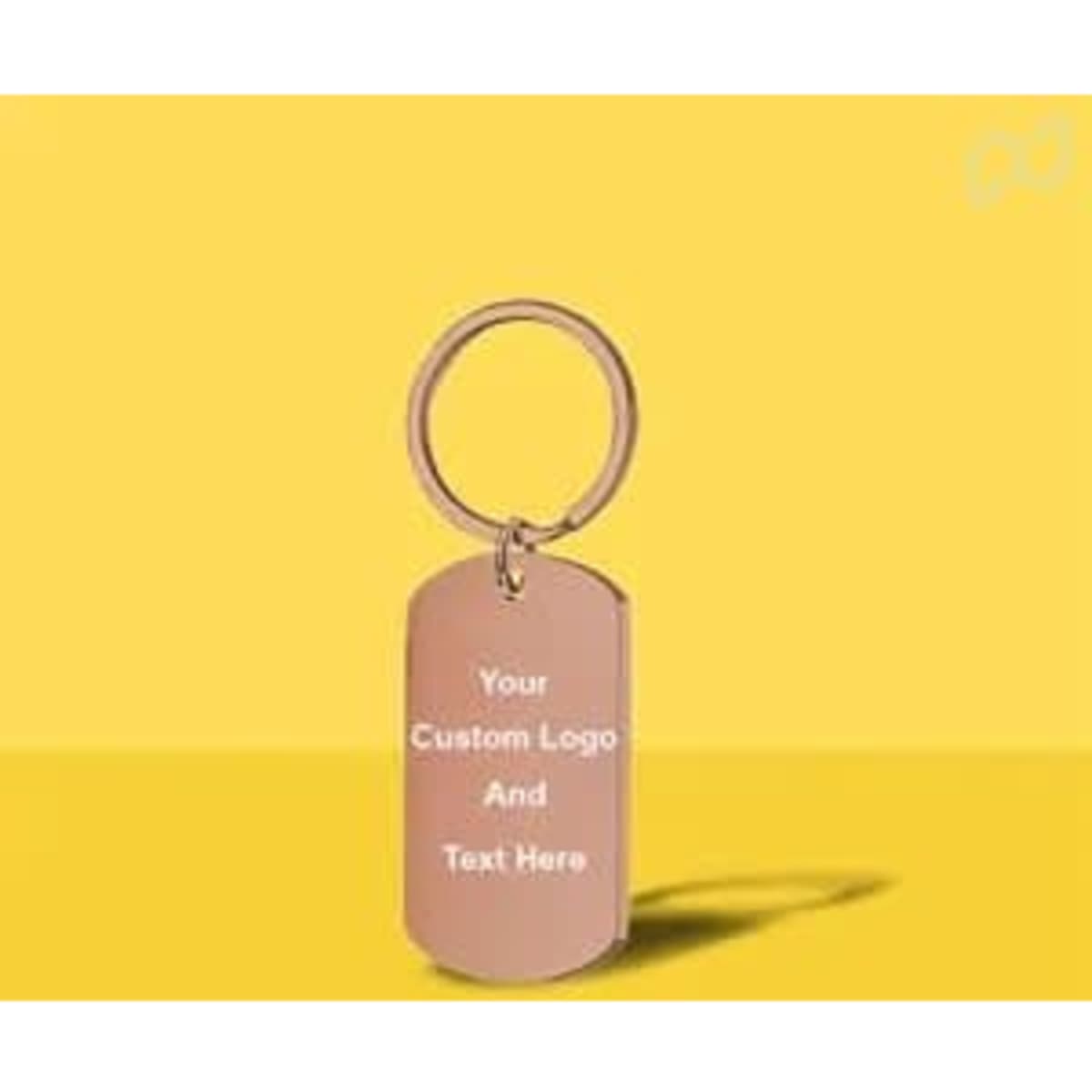 A rose gold keychain with a rectangular tag, featuring space for custom engraving and attached to a simple keyring.