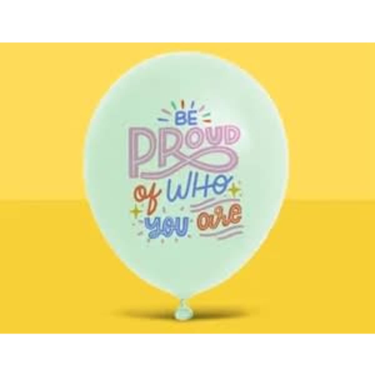 A pale green balloon with the text "Be Proud of Who You Are" printed in colourful letters and featuring a logo.