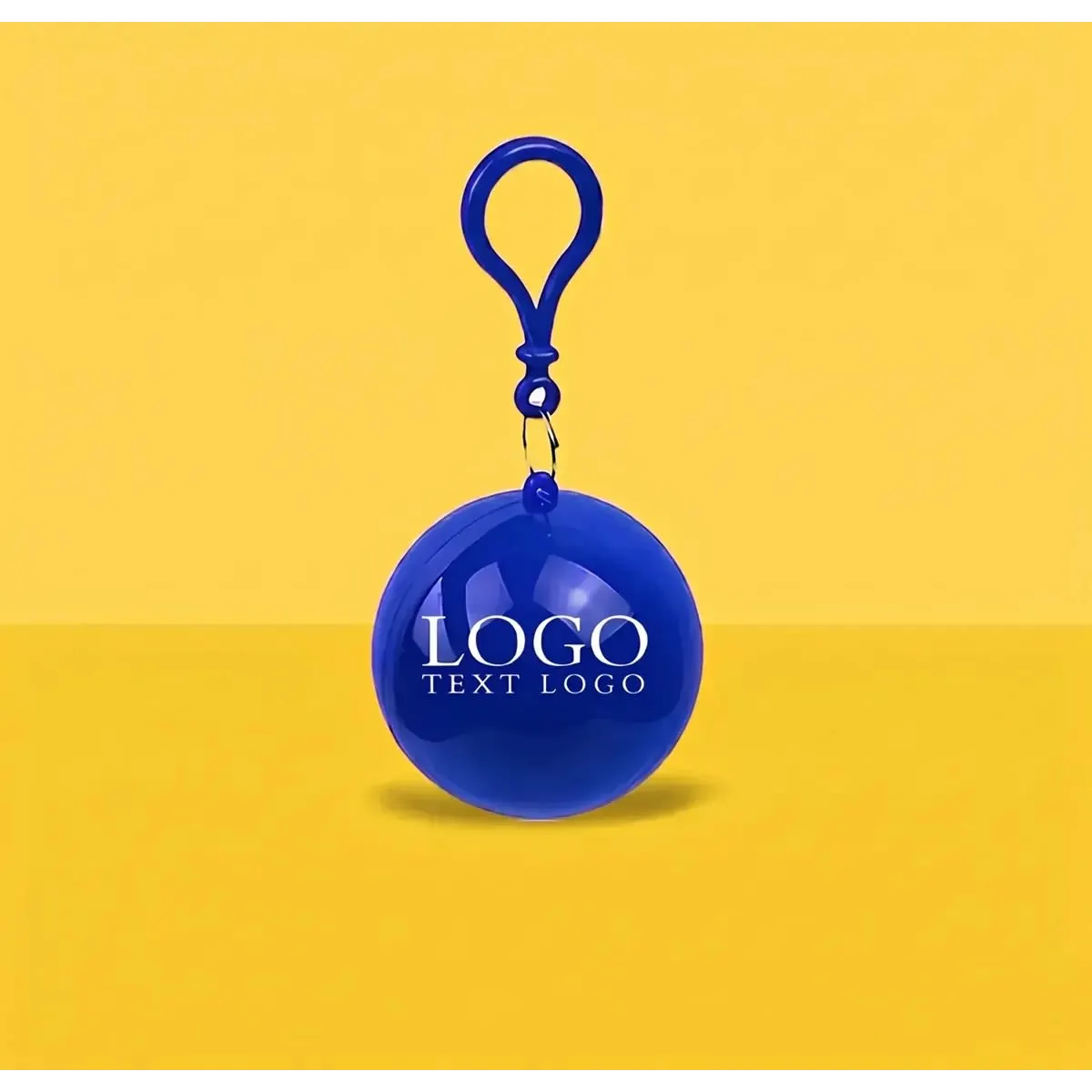 A blue keychain ball with a clip and a logo attached, set against a yellow background.