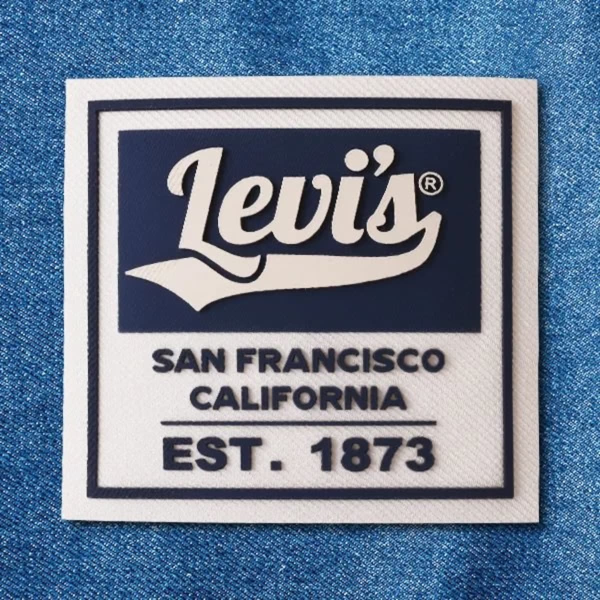 A blue and white 3D silicone patch featuring a logo and text associated with San Francisco, California.