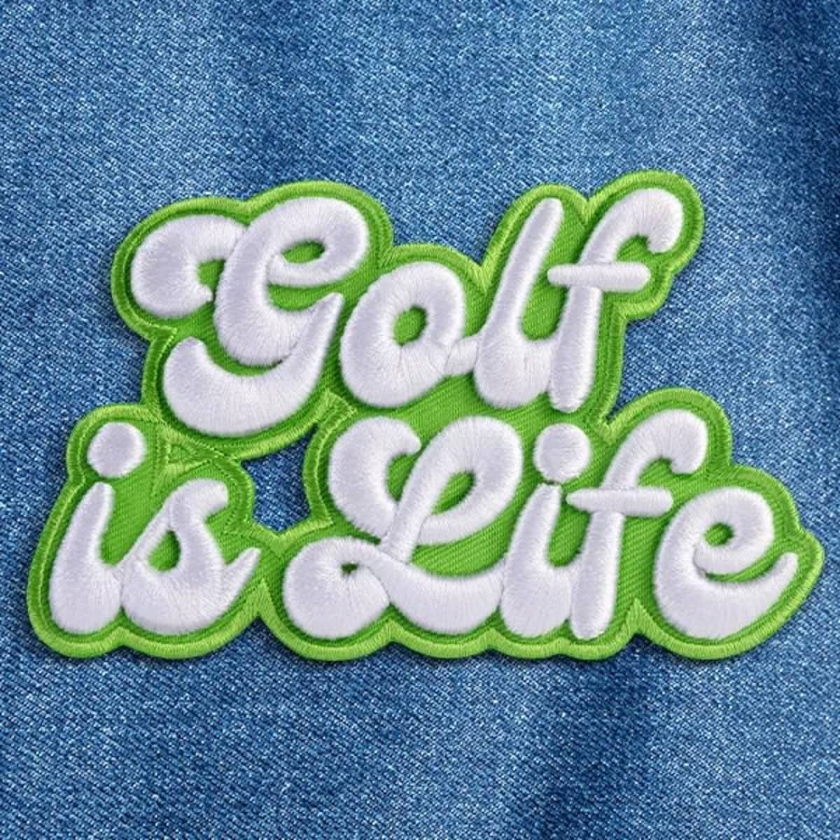 A green and white 3D embroidered patch featuring the phrase "Golf is Life" on a denim background.