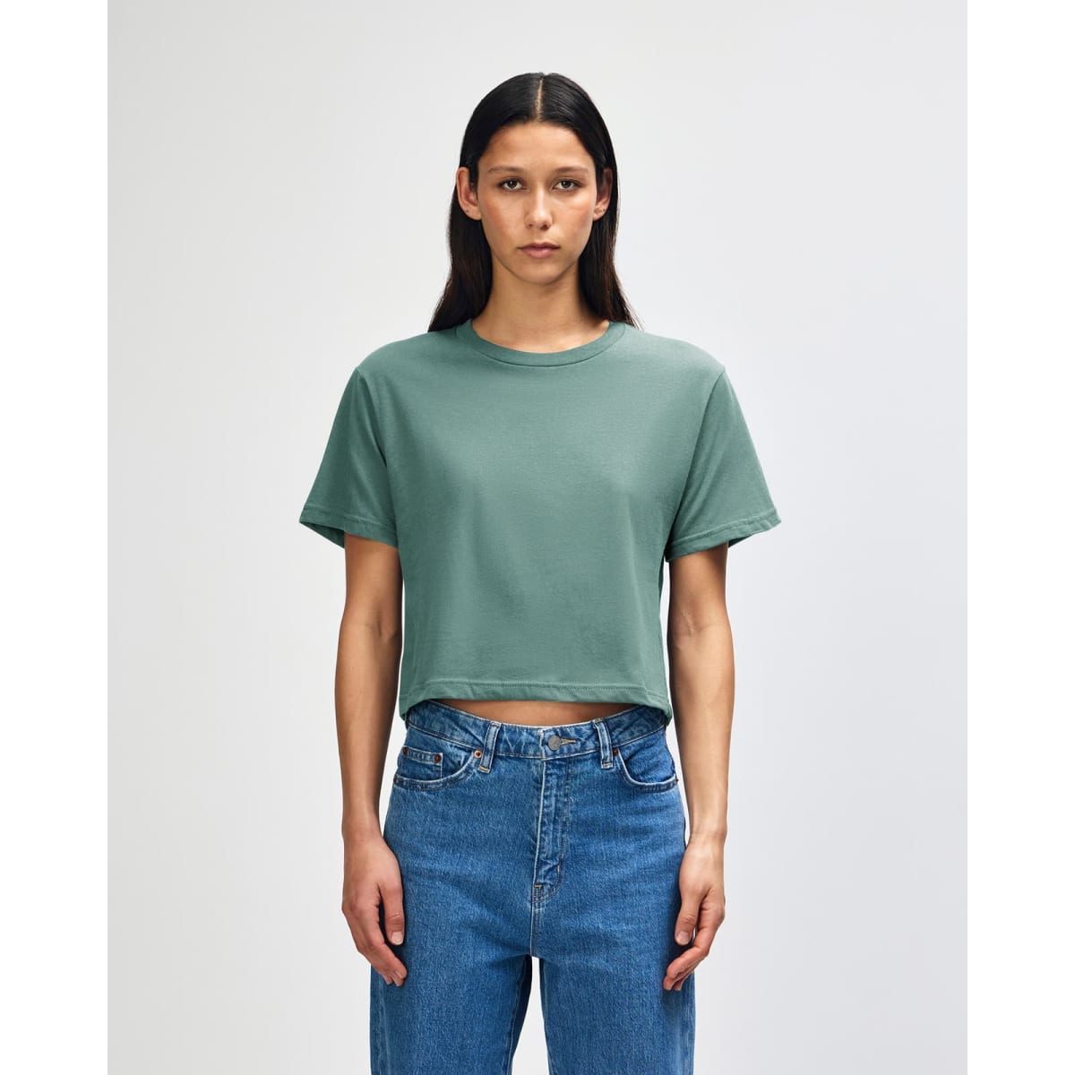 A women's boxy T-shirt in a soft green colour, featuring a classic crew neckline and short sleeves.