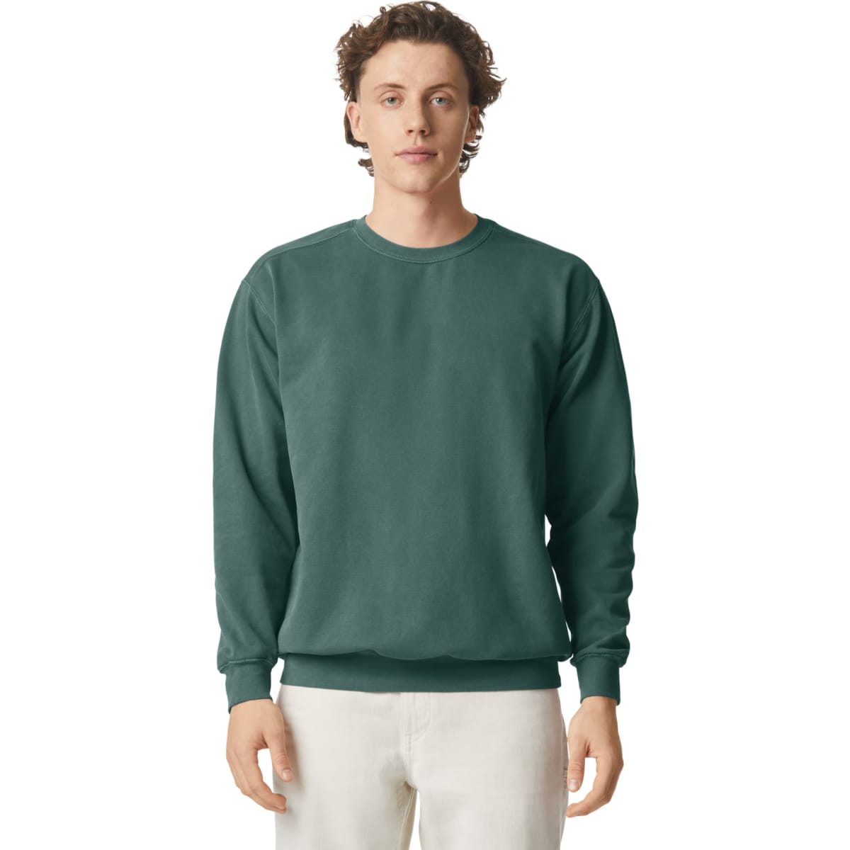 A green crewneck sweatshirt displayed on a model. The sweatshirt features a classic fit and ribbed cuffs.