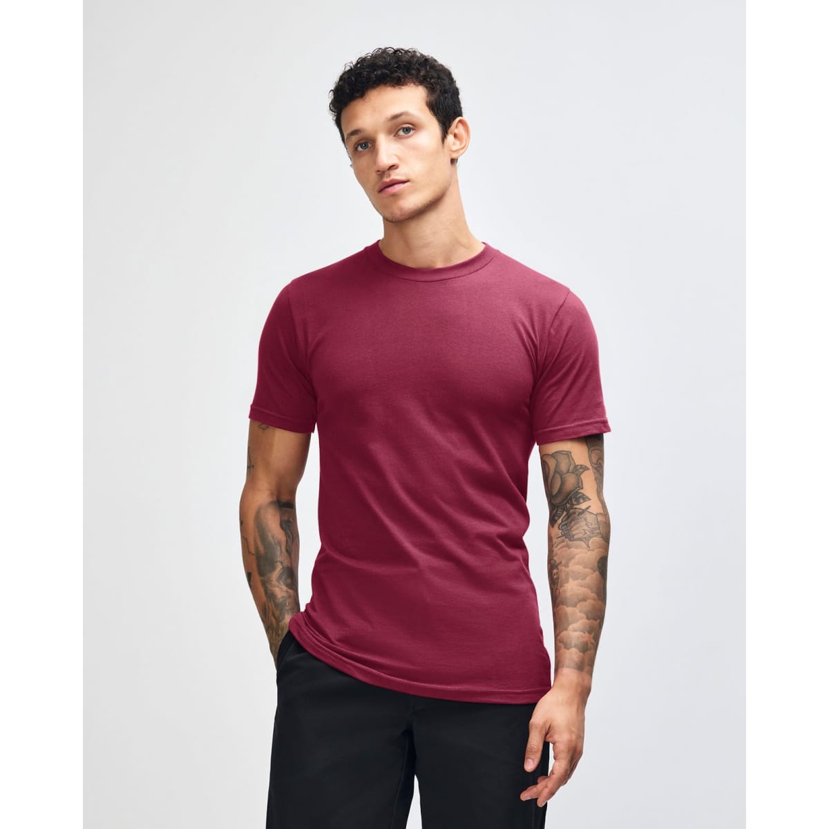 A maroon unisex short sleeve t-shirt with a crew neck, featuring a logo on the upper left chest.