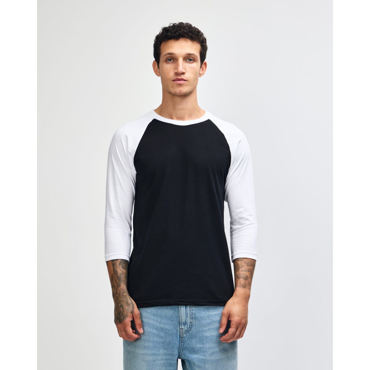 A unisex raglan T-shirt featuring black body and white sleeves, with a logo on the front.