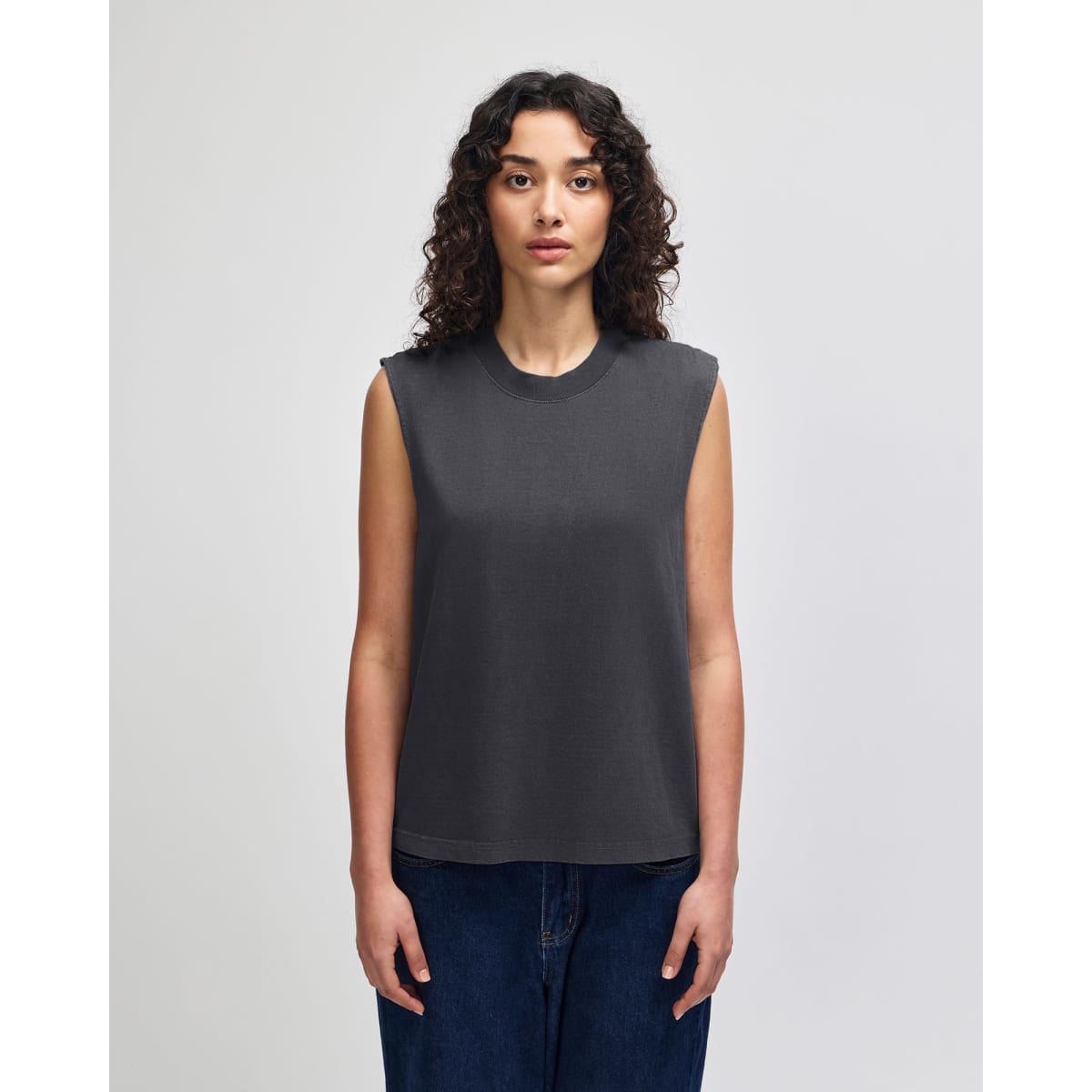 A grey unisex muscle t-shirt made from heavyweight cotton, featuring a boxy fit and sleeveless design.