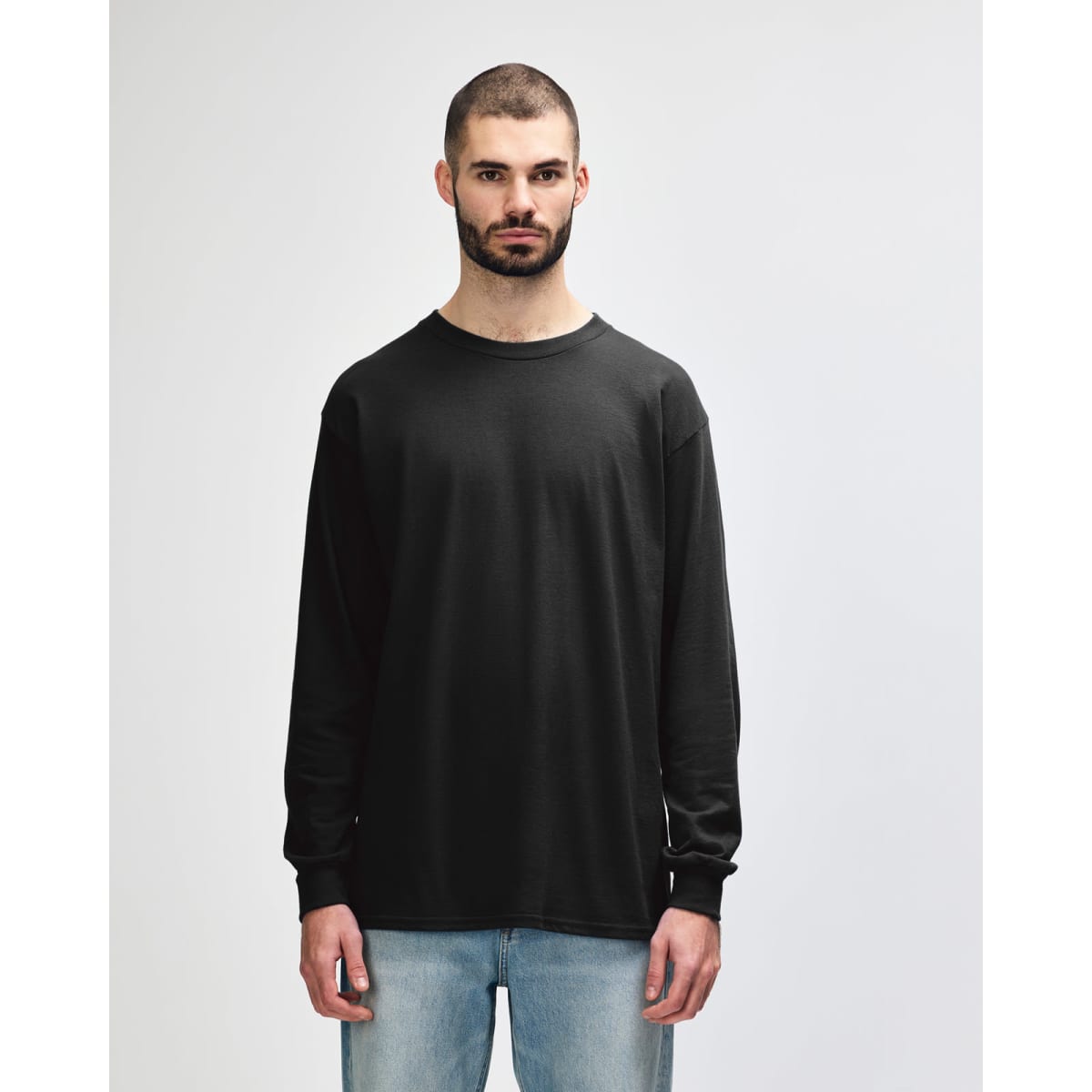 A long sleeve t-shirt in black, featuring a simple design and casual fit, with a logo on the front.
