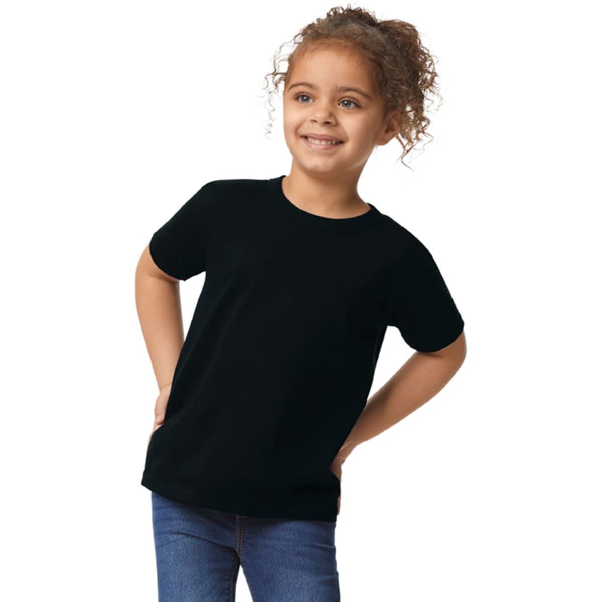 A toddler wearing a black Gildan Heavy Cotton T-shirt, featuring a logo, with curly hair and a playful expression.