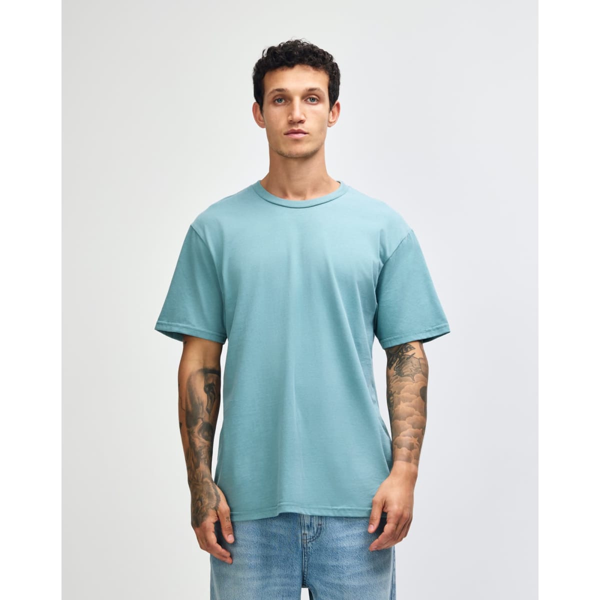A sueded unisex short sleeve t-shirt in a soft blue colour, featuring a relaxed fit and a visible logo.