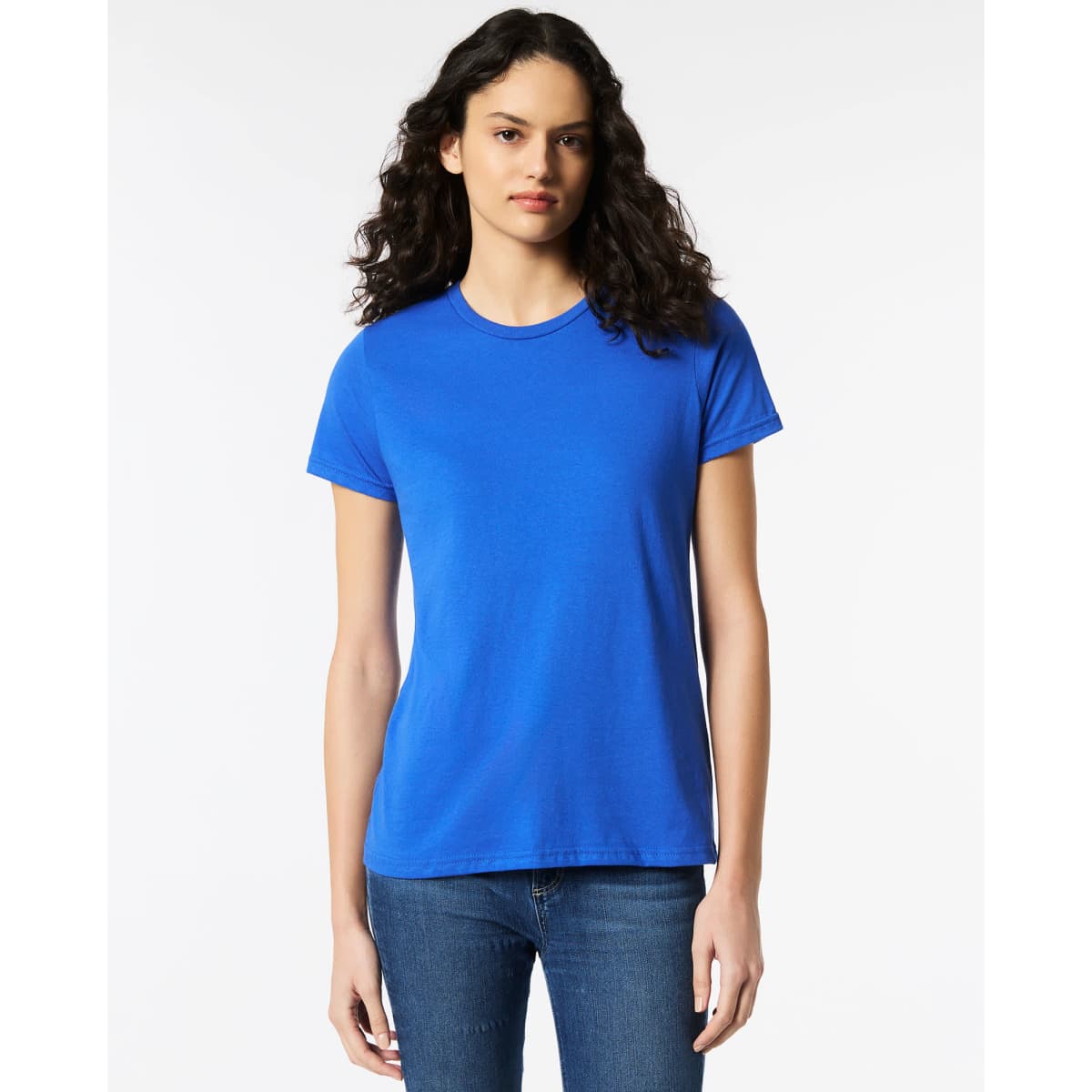 A blue Gildan Softstyle ladies' t-shirt displayed on a model, featuring a simple design and round neckline.