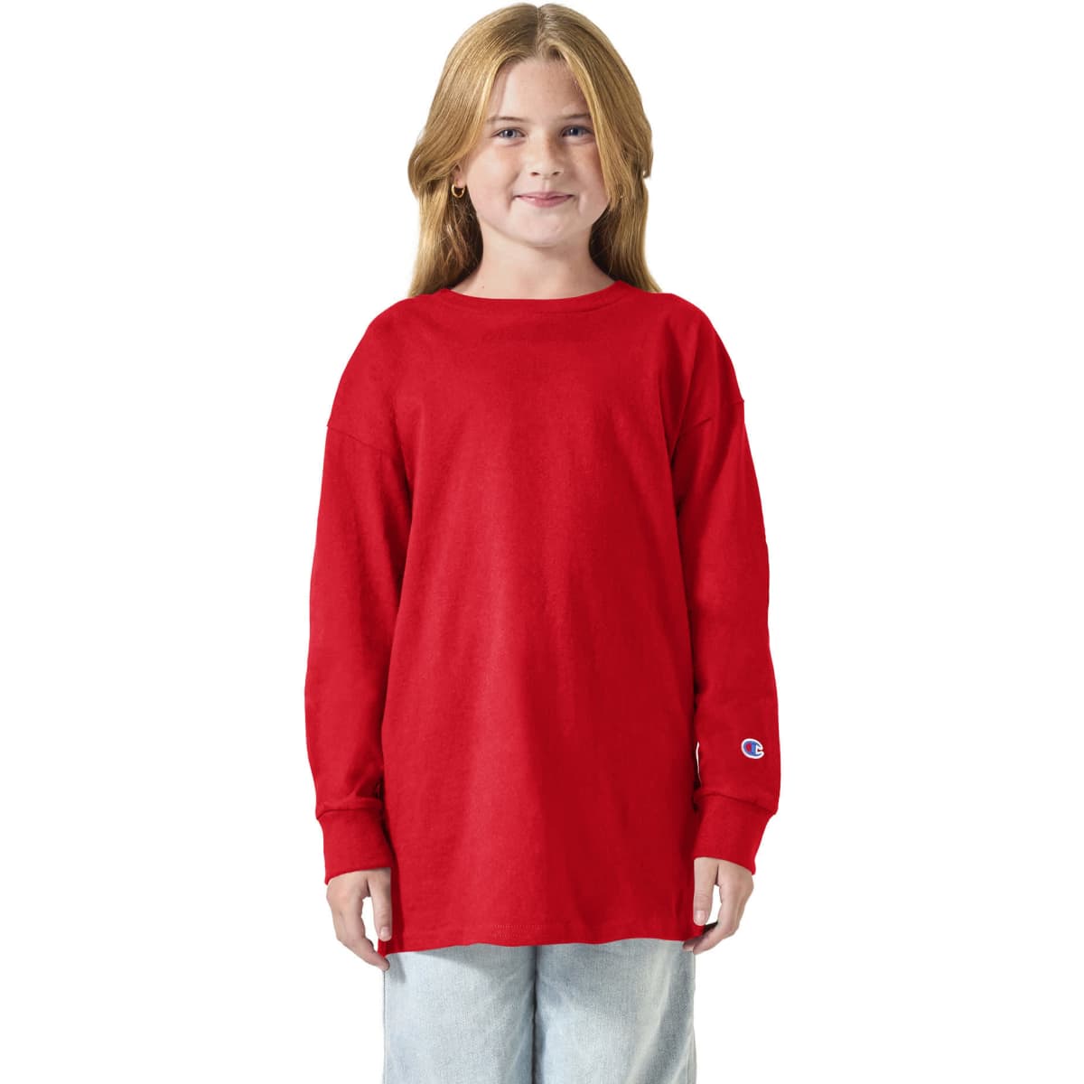 A red long sleeve t-shirt for youth, featuring a logo on the sleeve, worn by a child.