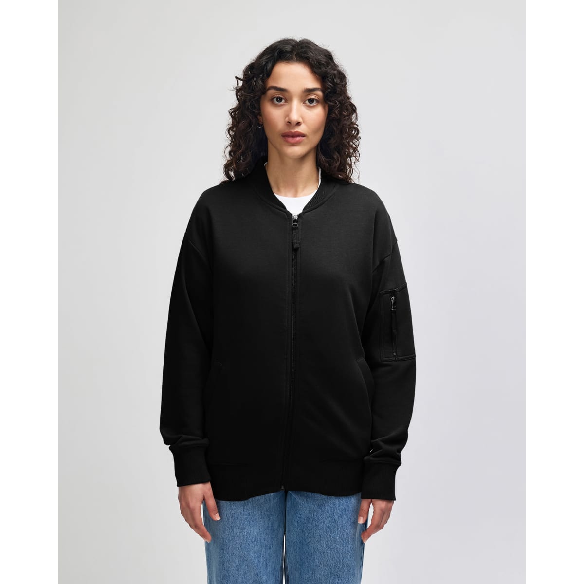 A black unisex bomber jacket made of French terry fabric, featuring a zip front and ribbed cuffs.