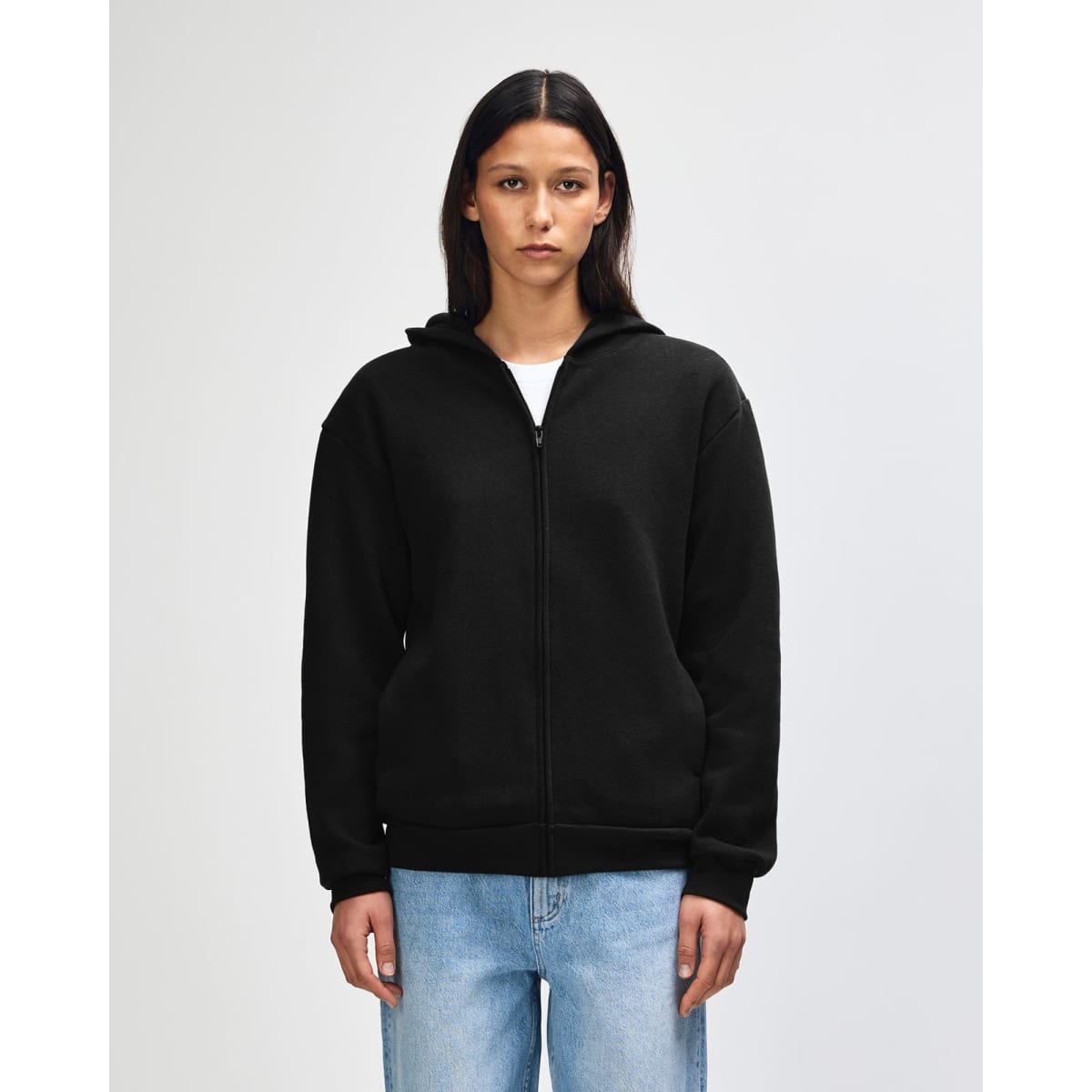 A black unisex full zip hooded sweatshirt displayed on a model. The garment features a logo.