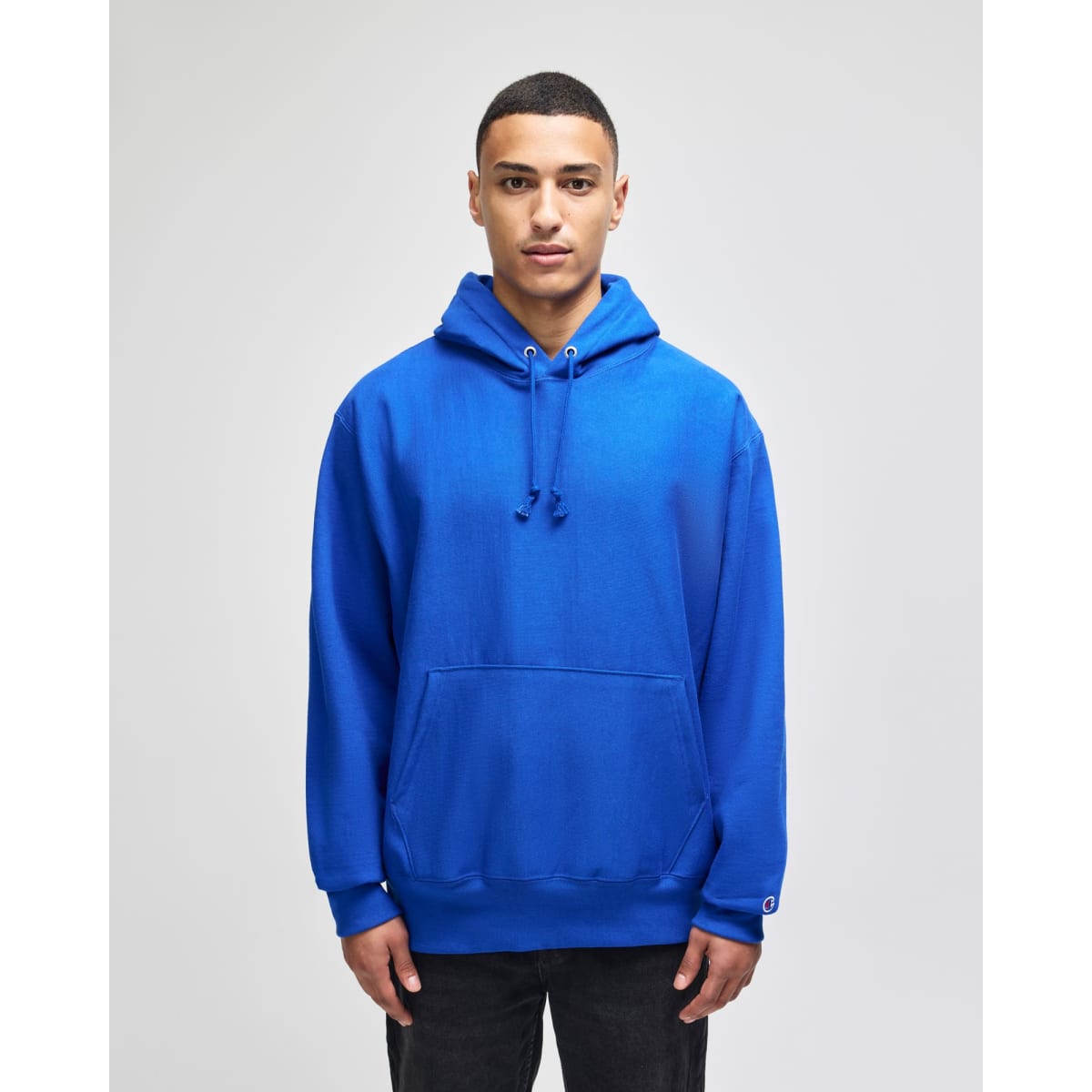 A blue pullover hooded sweatshirt with a front pocket and a logo detail.