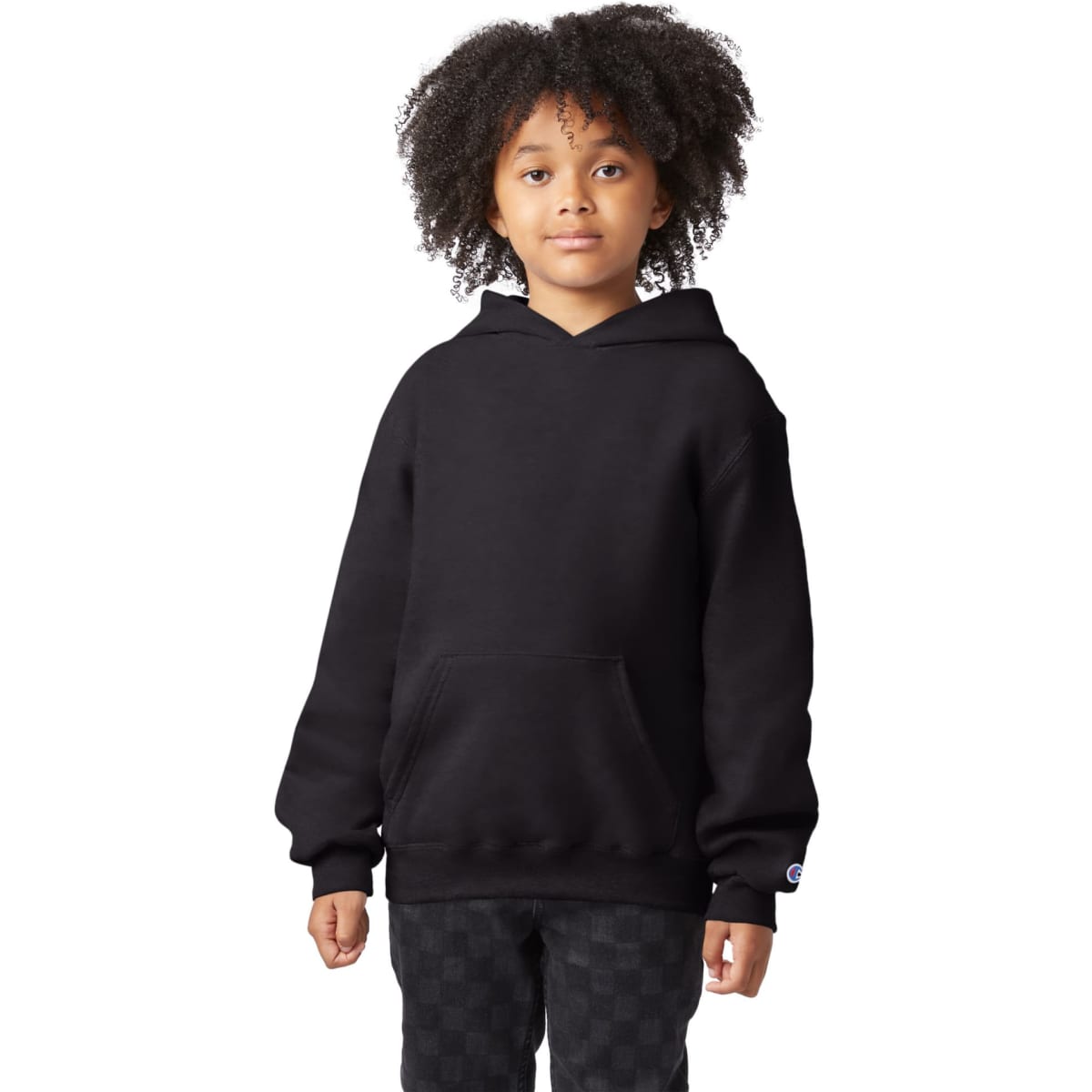 A black hooded sweatshirt with a front pocket, featuring a logo on the sleeve. The model has curly hair.