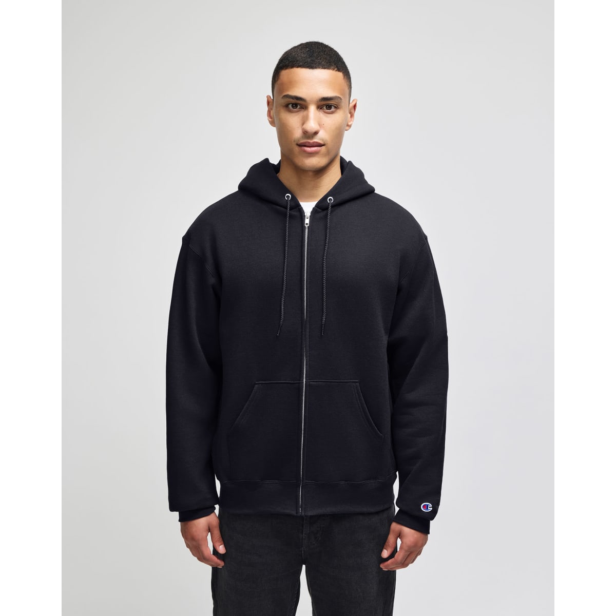 A black full-zip hooded sweatshirt with a front zipper and a logo on the sleeve.