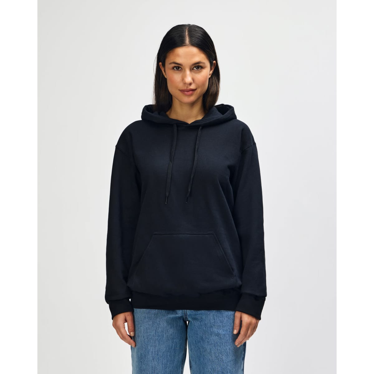 A black hooded sweatshirt worn by a model with a front pouch pocket and drawstring hood. Features a logo.