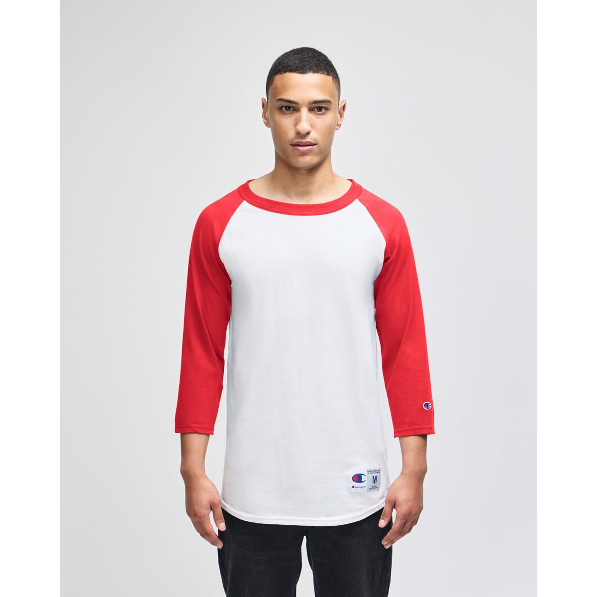 A white and red Champion Adult Raglan Baseball T-Shirt with three-quarter sleeves and a logo.
