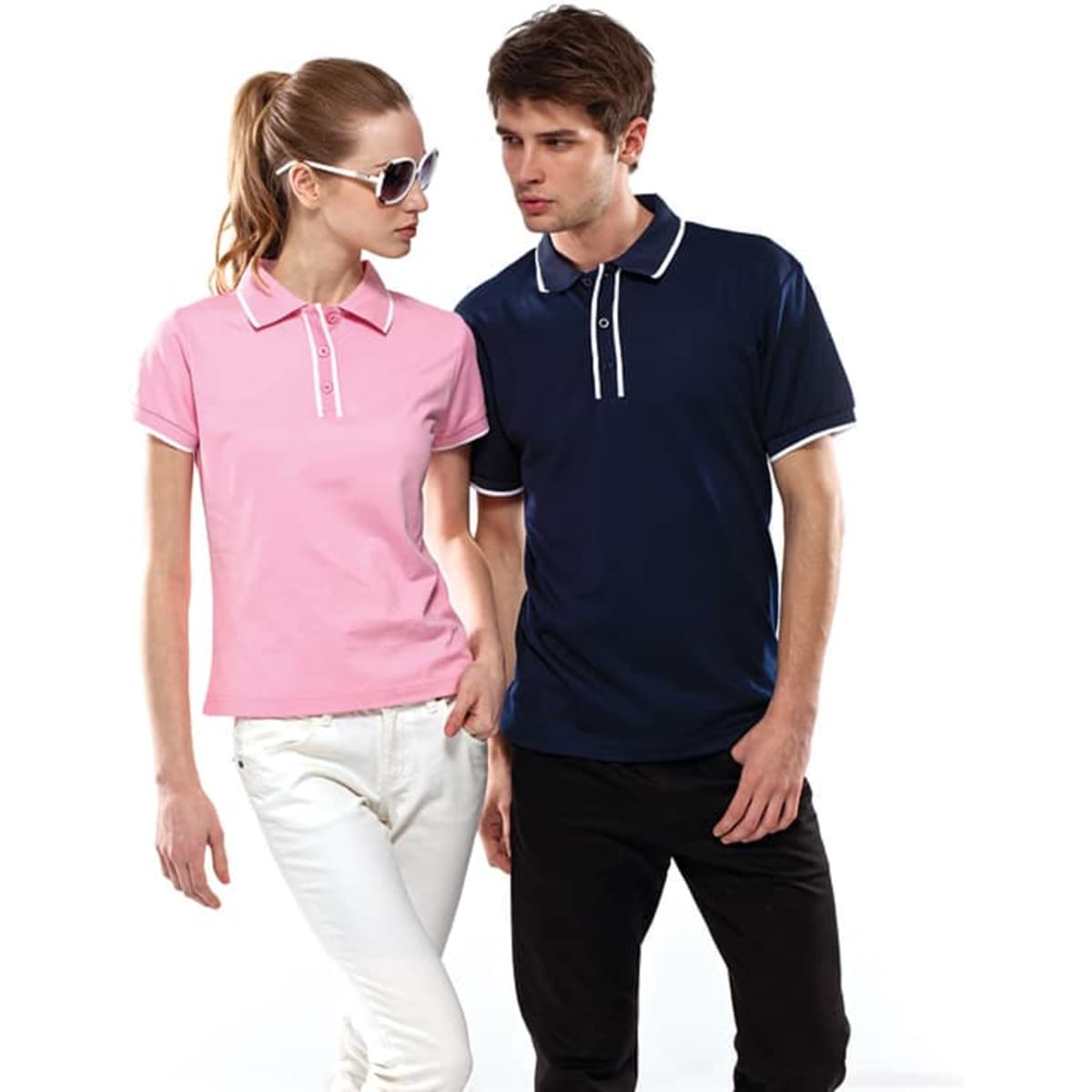 Two models wear "Blade Polos" in pink and navy blue, featuring contrasting trims and a logo on the polo shirts.